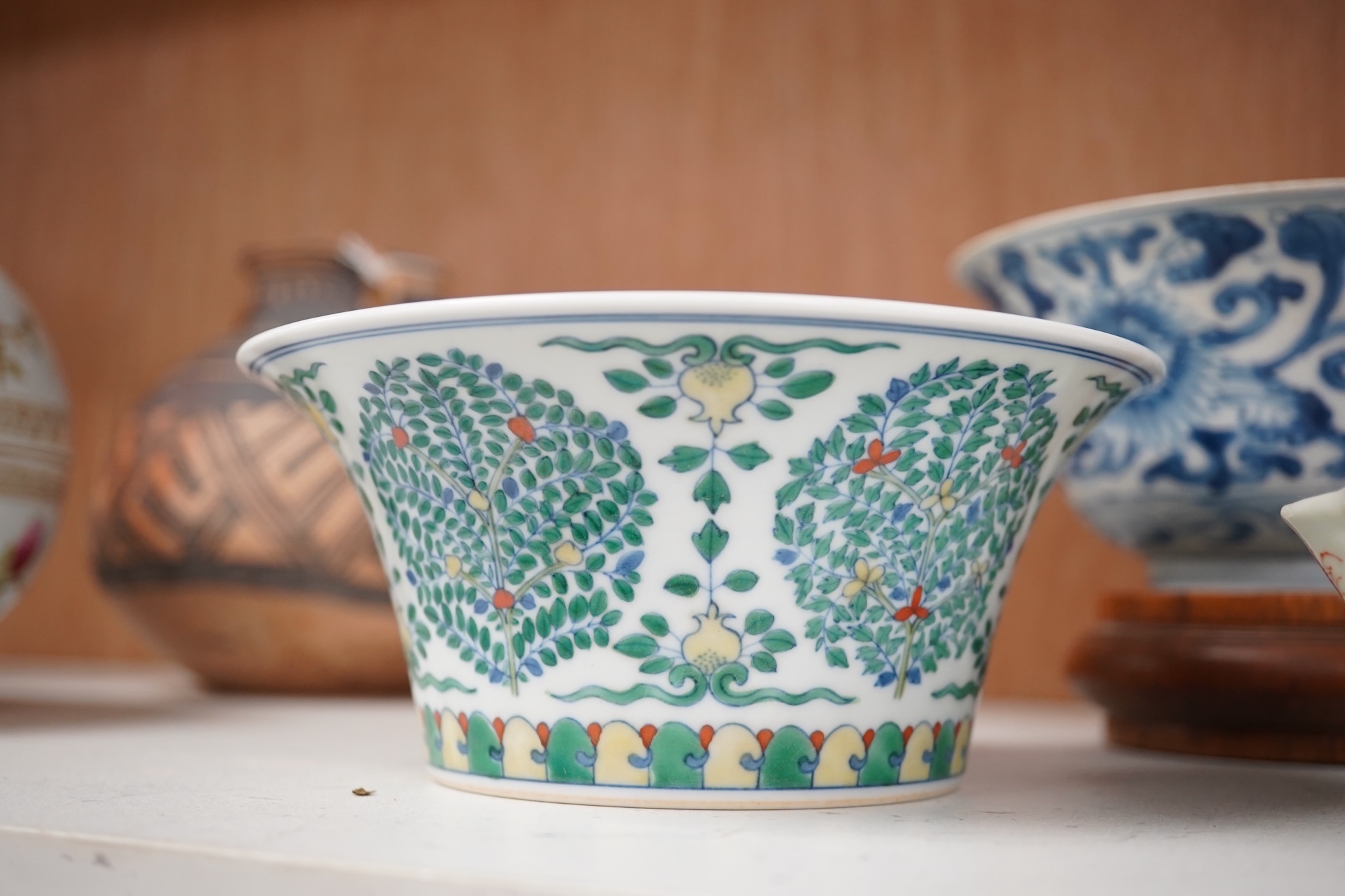 A Chinese blue and white bowl, Kangxi, 15cm. diam., a famille rose teapot stand, Yongzheng, and two doucai bowls. Condition - varies